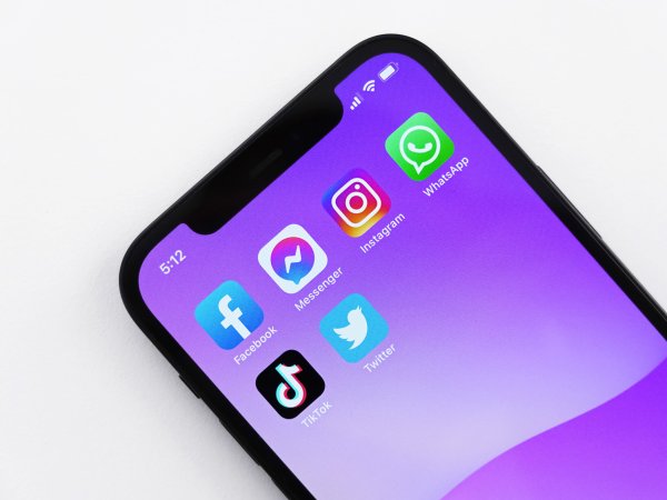 An iPhone with Facebook, Facebook Messenger, Instagram, WhatsApp, TikTok, and Twitter apps visible.