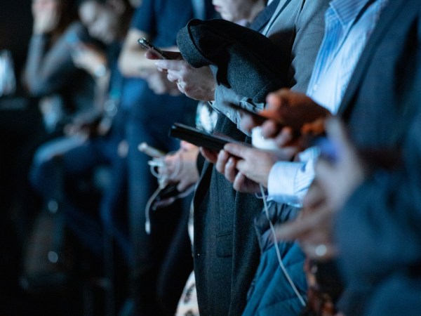 A group of people all using their phones.