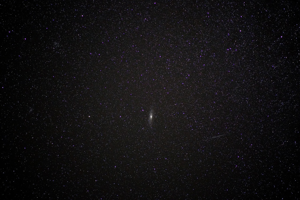 Starry night sky with a comet in the center