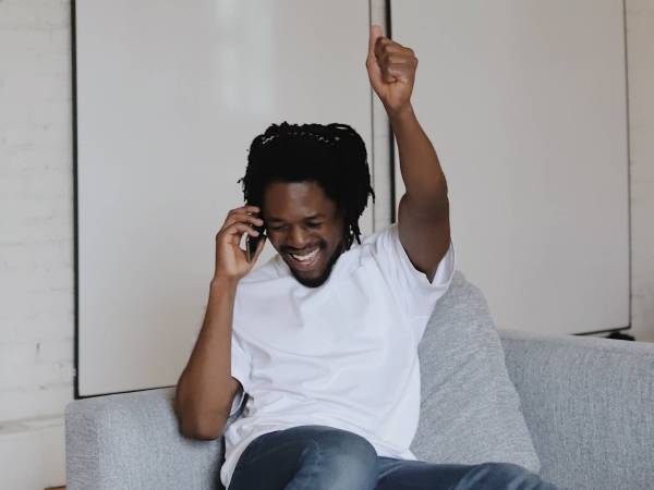 man celebrating on the phone