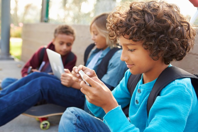 Kids playing on phones and computers gaming ads