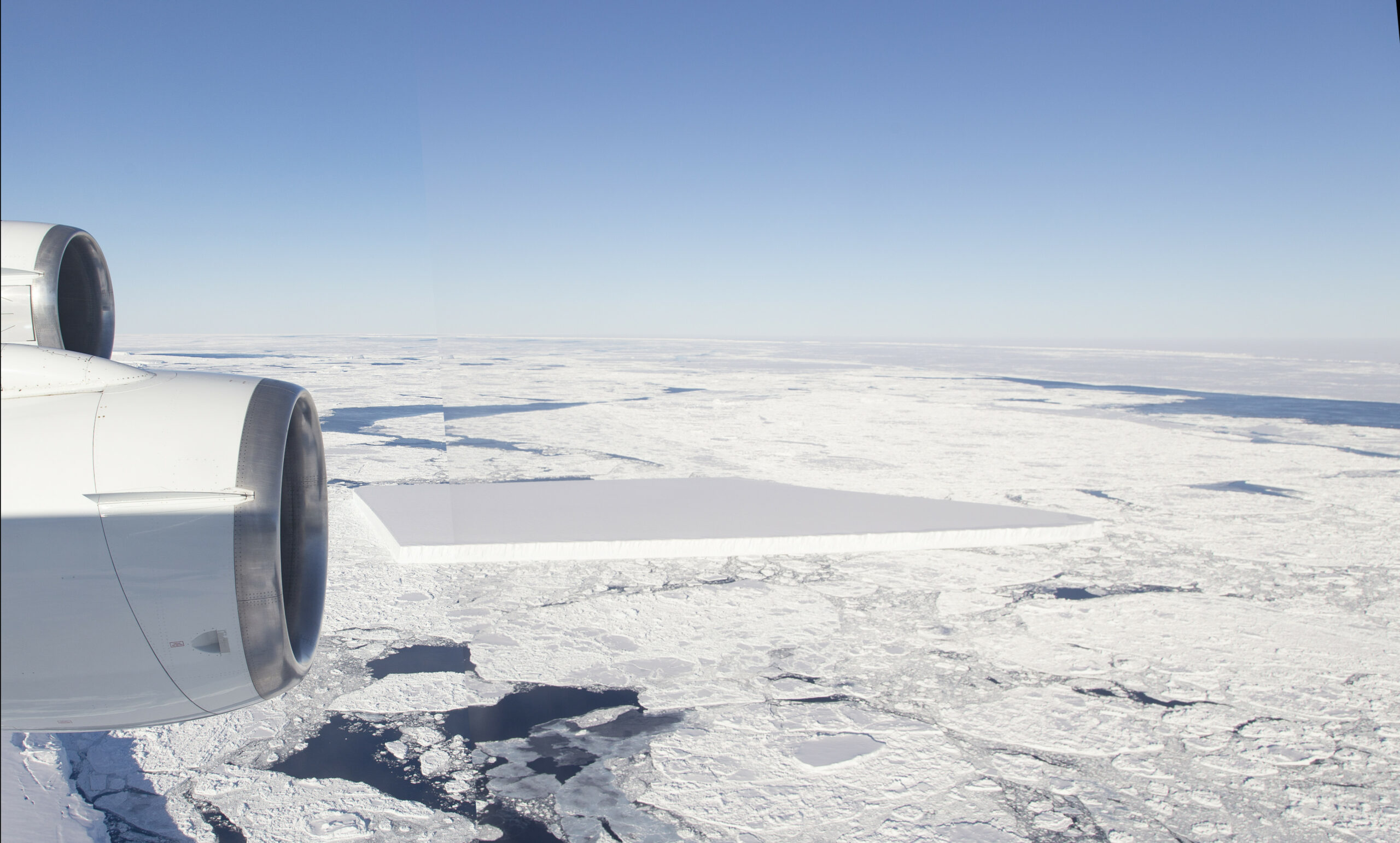 a plane flies over a rectangular iceberg