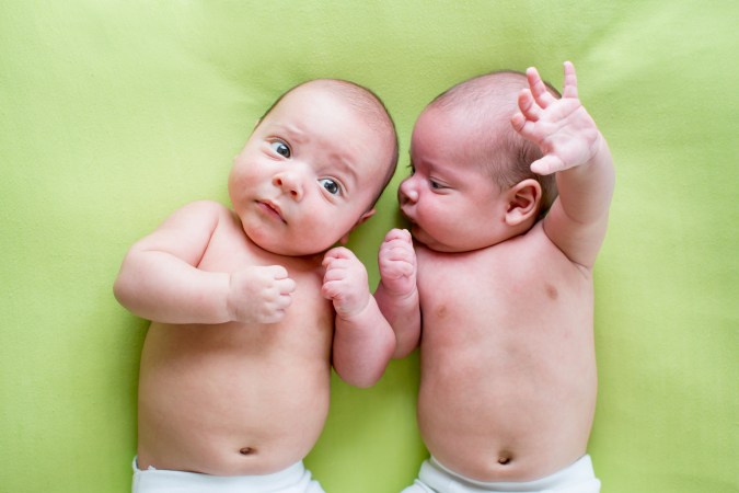 two babies on a green background