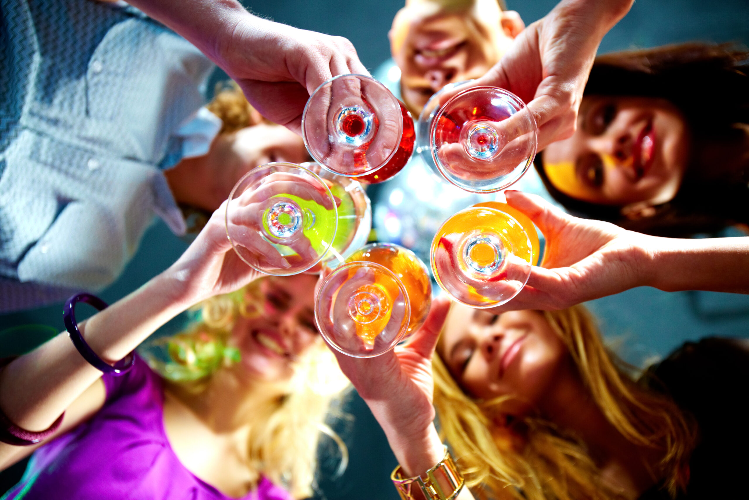 a group of people toasting wine glasses