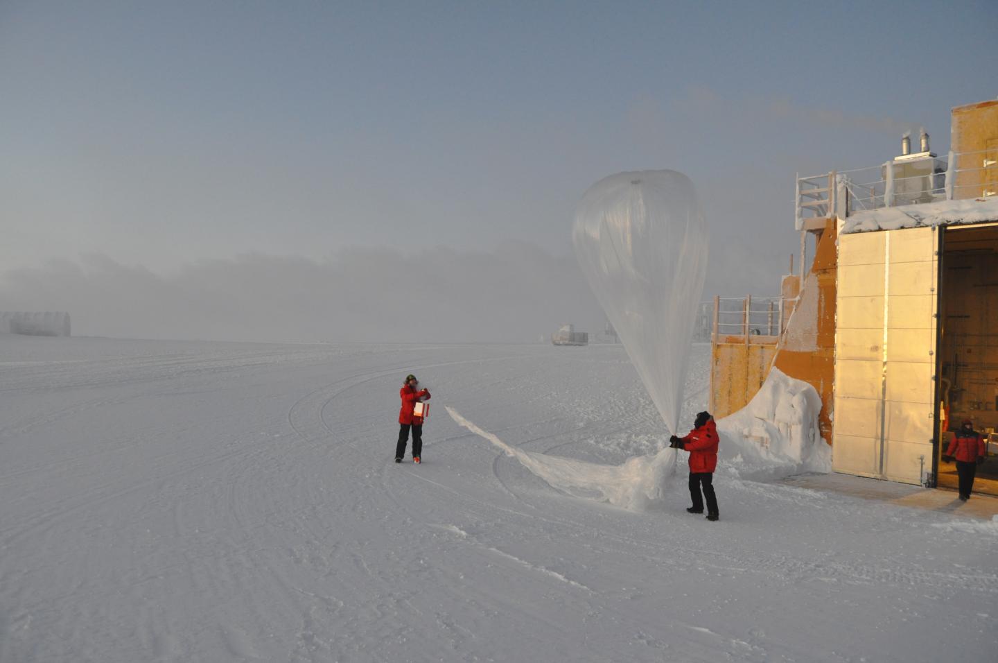 two people release a balloon