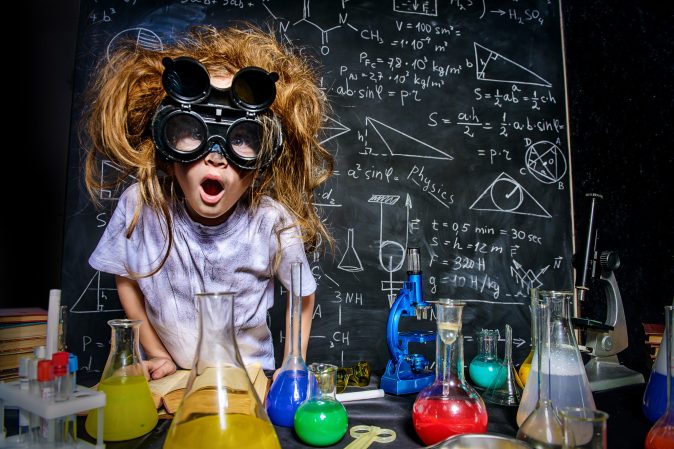 a kid playing with lab equipment 