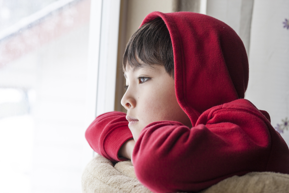 boy staring out window