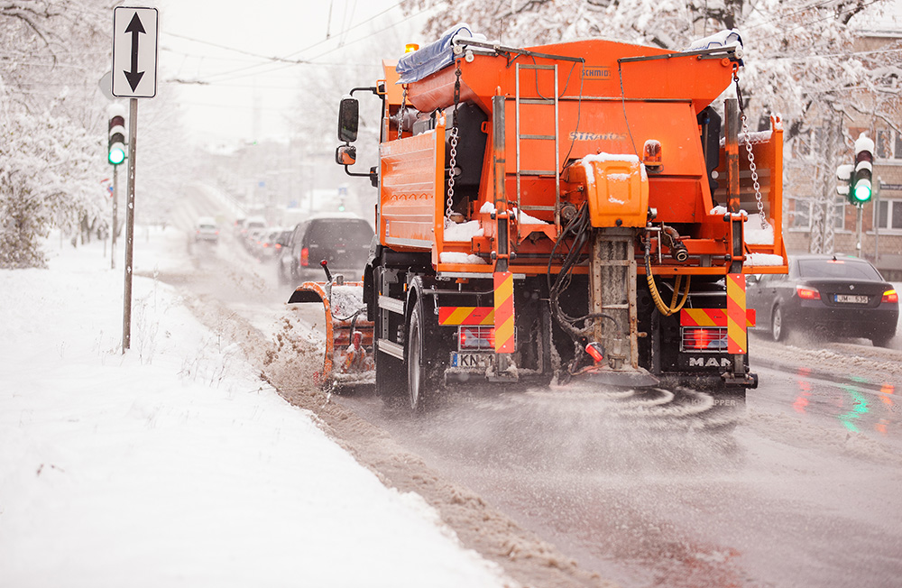 Snow plow Spraying salt onto roads