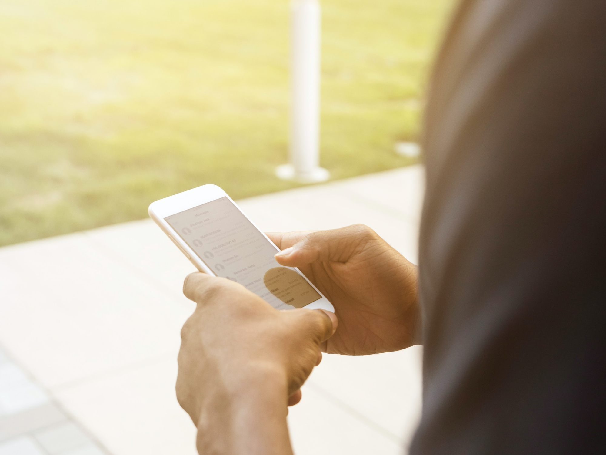 A person looking through messages on their phone, maybe trying to find their group chats.