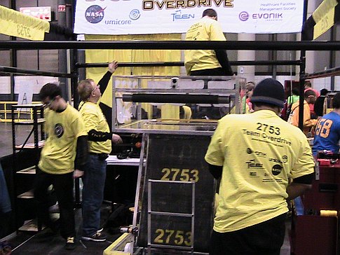 Teenagers with a homemade robot at the 2009 FIRST Robotics Competition in New York City.