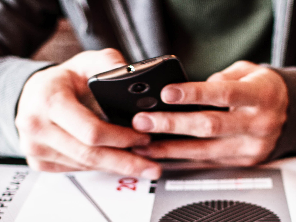 A person holding a smartphone in their hands.