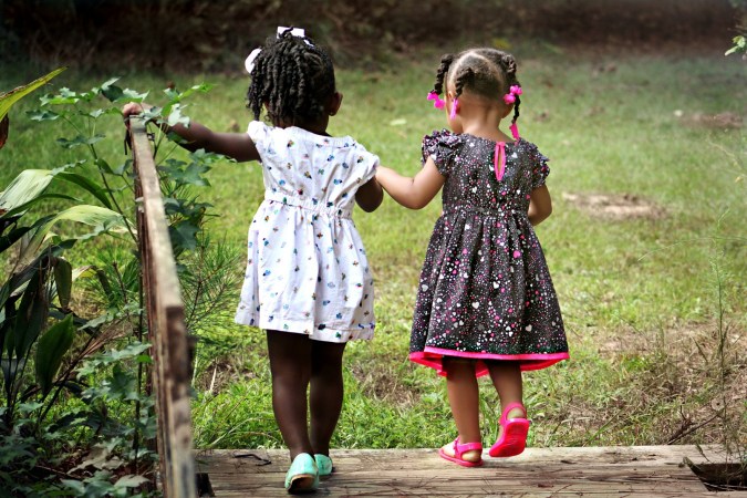 two children walking outside