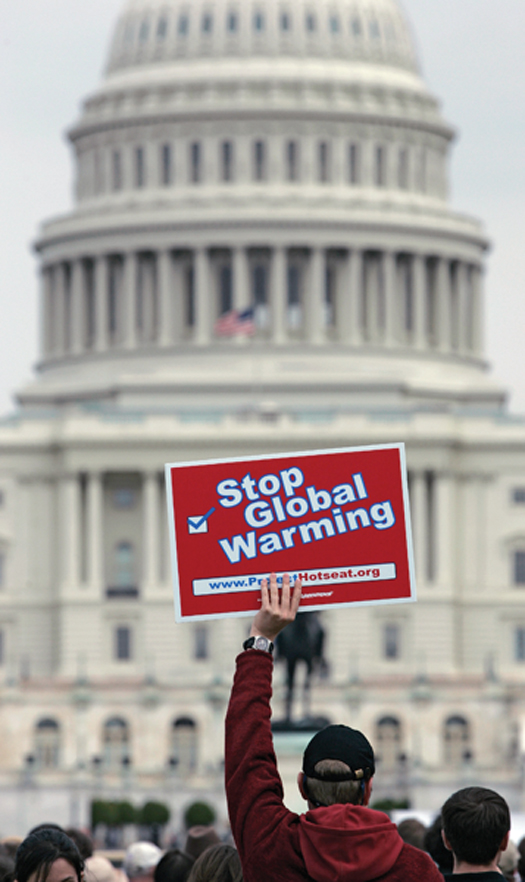 a protester holding a "stop global warming" sign