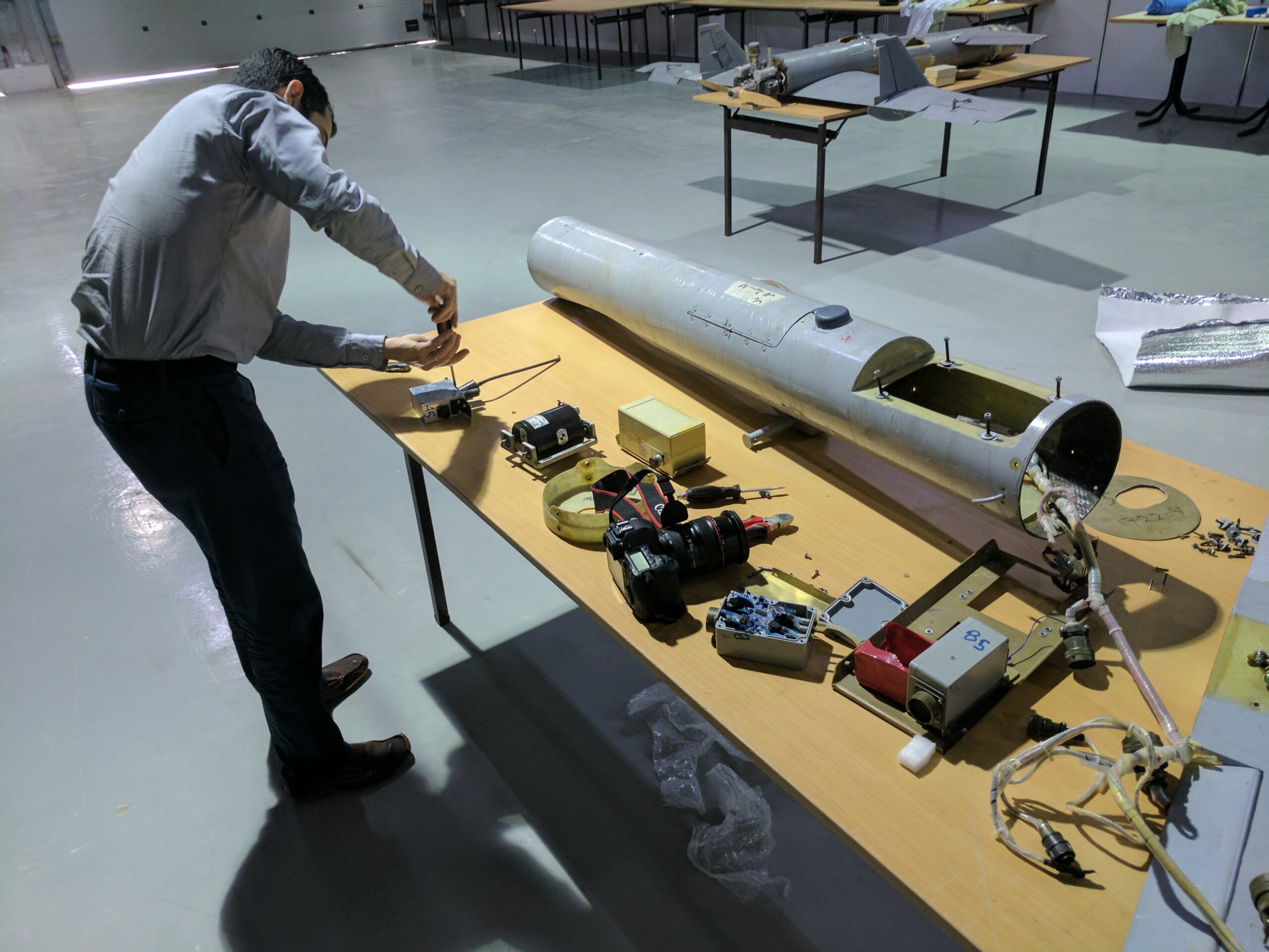 Researcher examining a Qasef-1