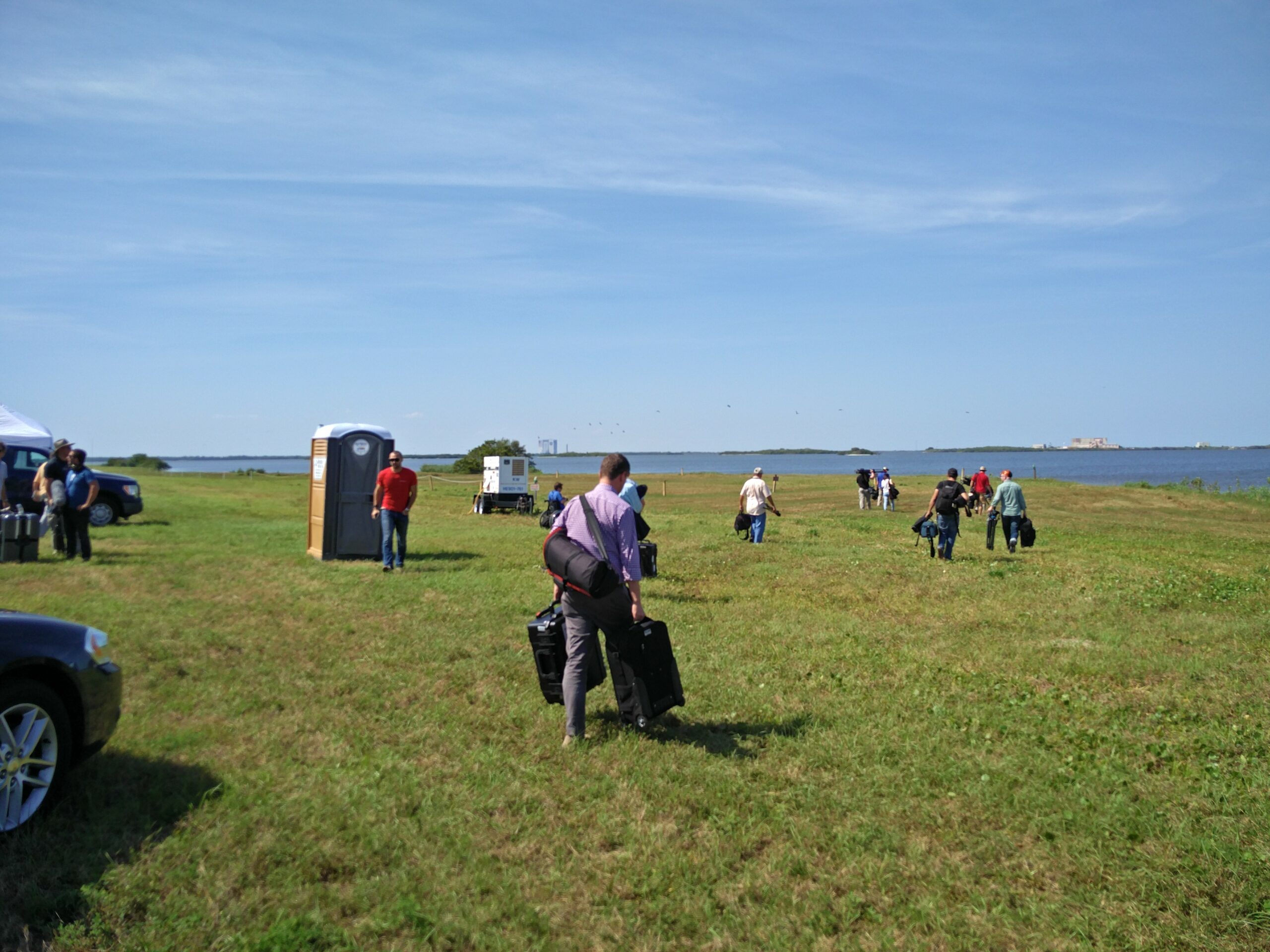 field with a port-a-potty in it