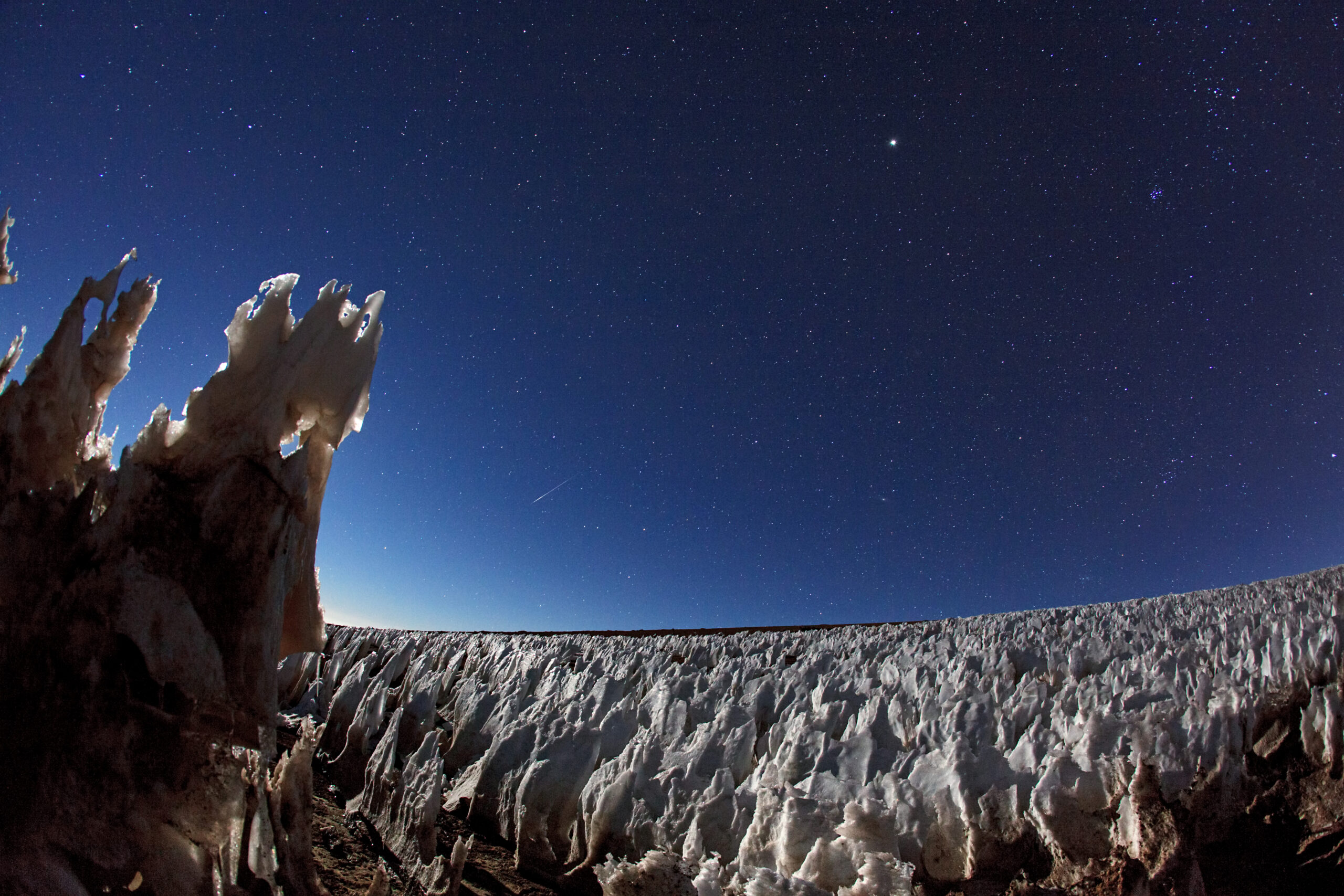 blades of snow and ice under a dark sky