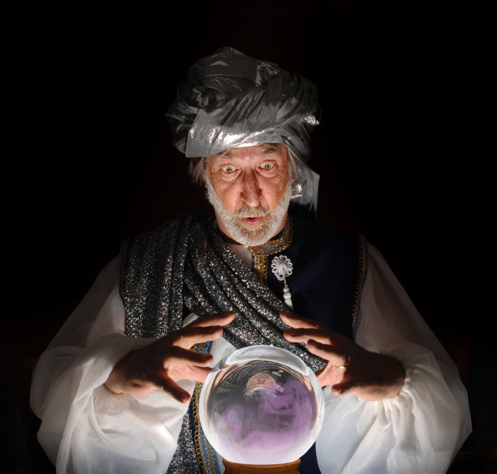 Old fortune teller looking into a magic crystal ball