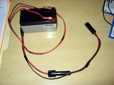 A wired pocket generator with black cylindrical ends.