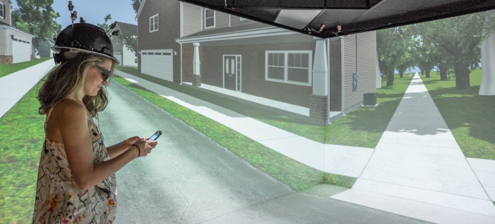 A woman texting in a virtual reality experiment.