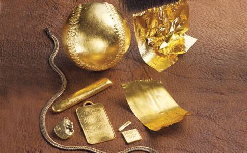 A number of objects covered in gold, including a baseball.