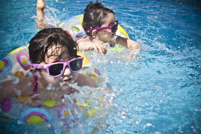 Two kids in a swimming pool full of bacteria