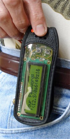 A Pass Key password-maker in a leather case on a person's belt.