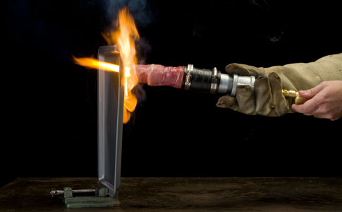 A thermal lance made out of bacon cutting a steel pan in half.