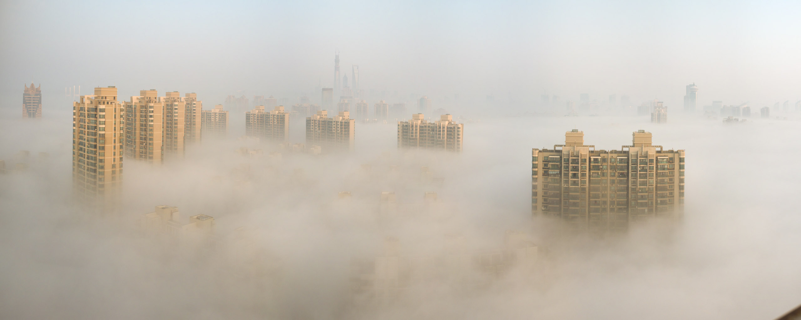 Shanghai skyscrapers surrounded by smog