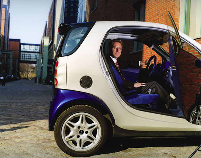 Daimler-Chrysler's Ralf Herrtwich sitting in a mini car