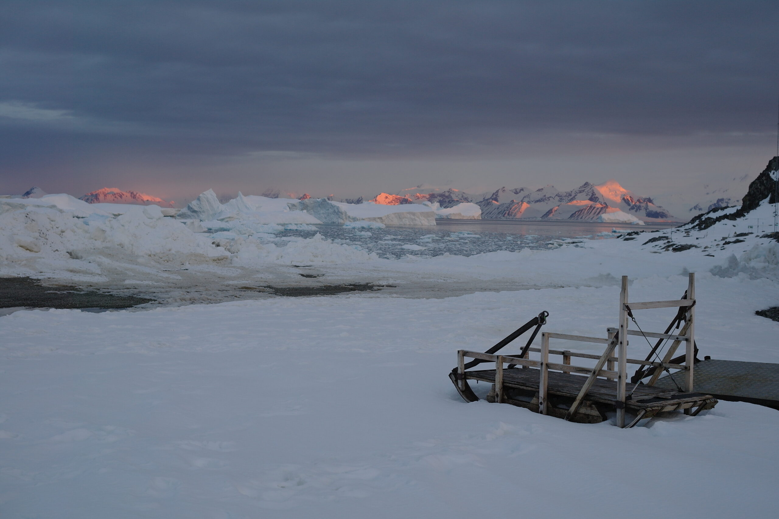 the sun sets over antarctica