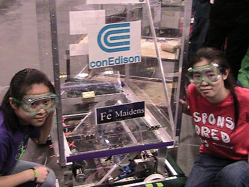 Two high school girls with a homemade robot at the 2009 FIRST Robotics Competition in New York City.