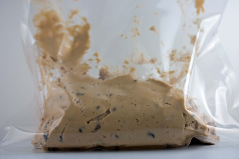 Chocolate chip cookie dough in a plastic bag.