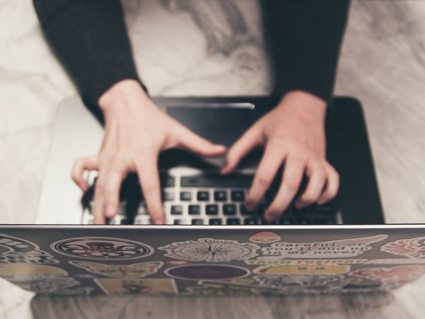 A person typing on a laptop.