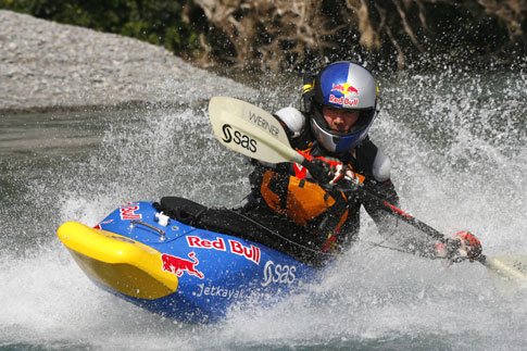 Shaun Baker in a jet-powered kayak on a river.