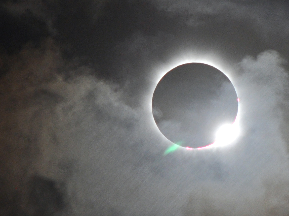 total solar eclipse through clouds