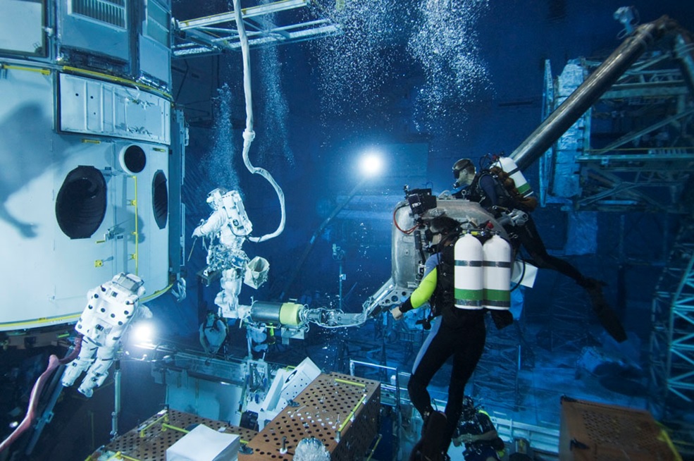 A team of astronauts & divers on an underwater mission