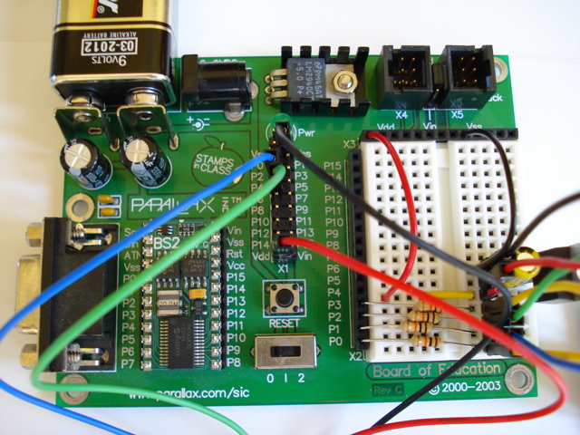 A microcontroller with wires attached to it.