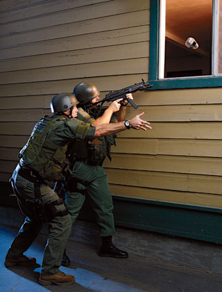 LASD deputies toss a video camera through a window