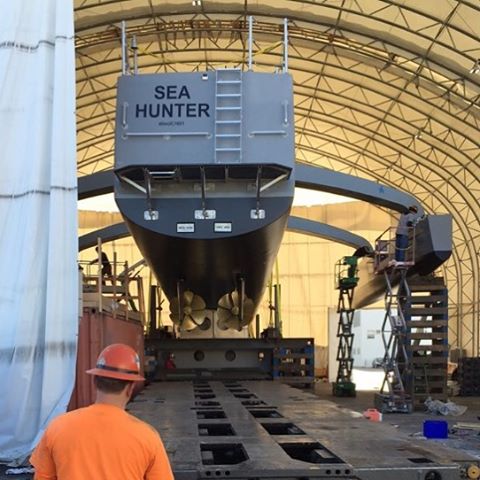 Backside view of the ACTUV Sea Hunter in a hangar with a technician