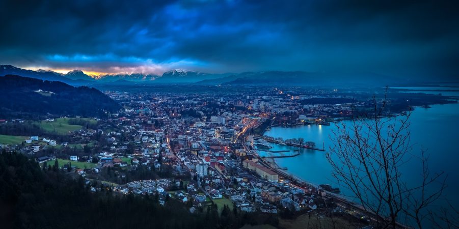 city near a lake at dusk