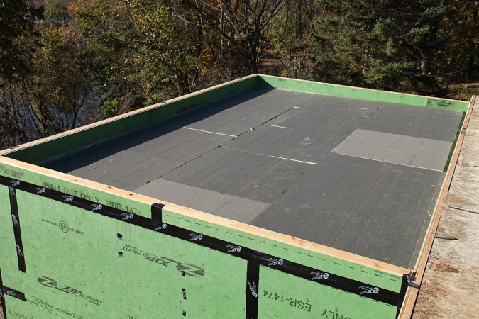 A building roof with black insulation on top.