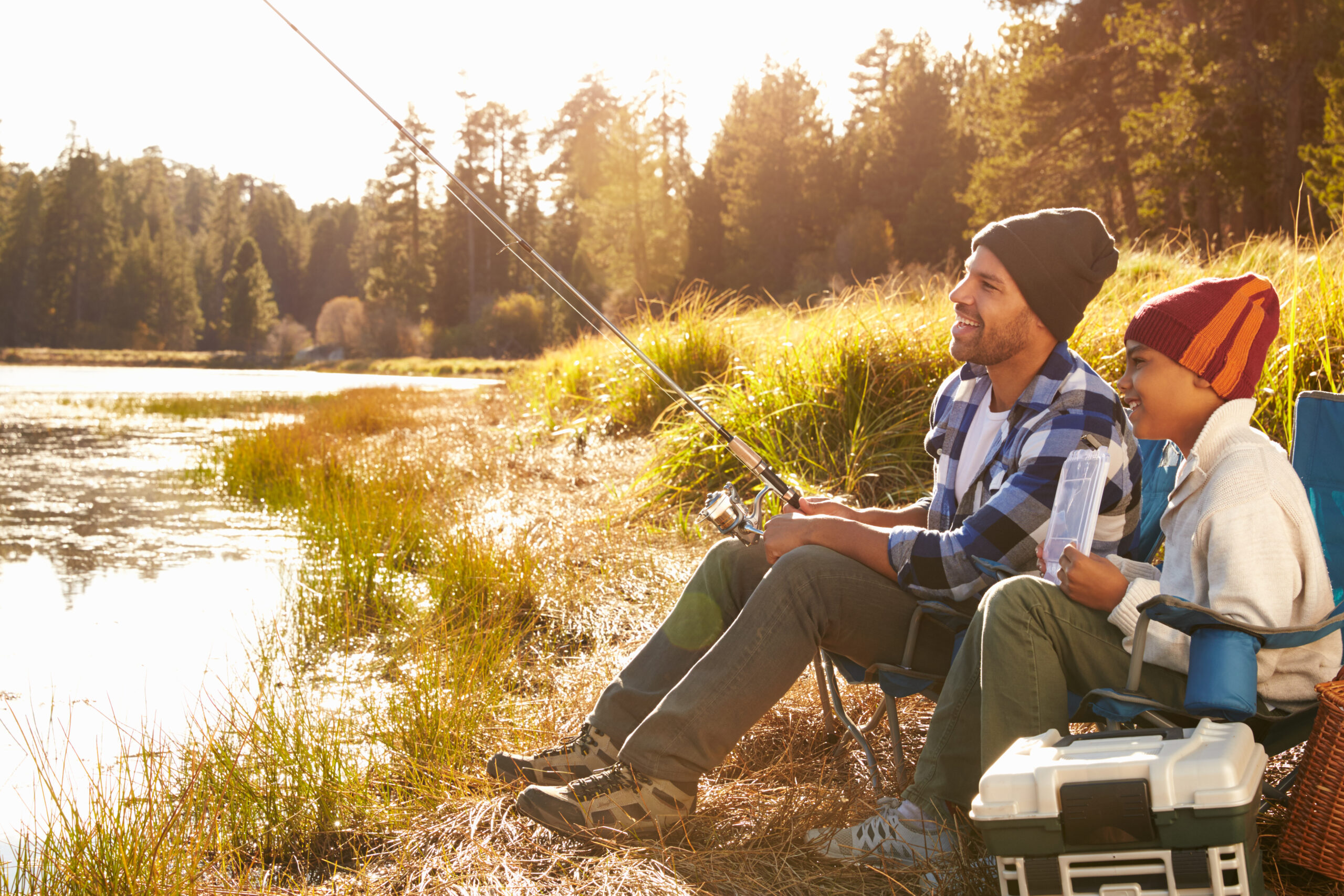 a father and son fishing on a lake