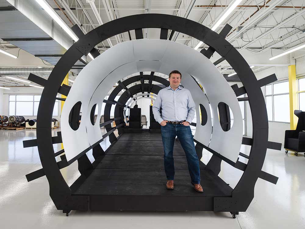 blake sholl standing in a plane frame