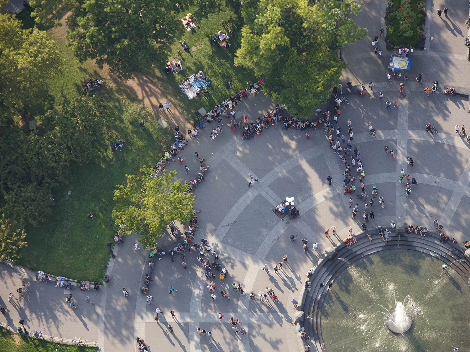 fountain in the center of crowded park