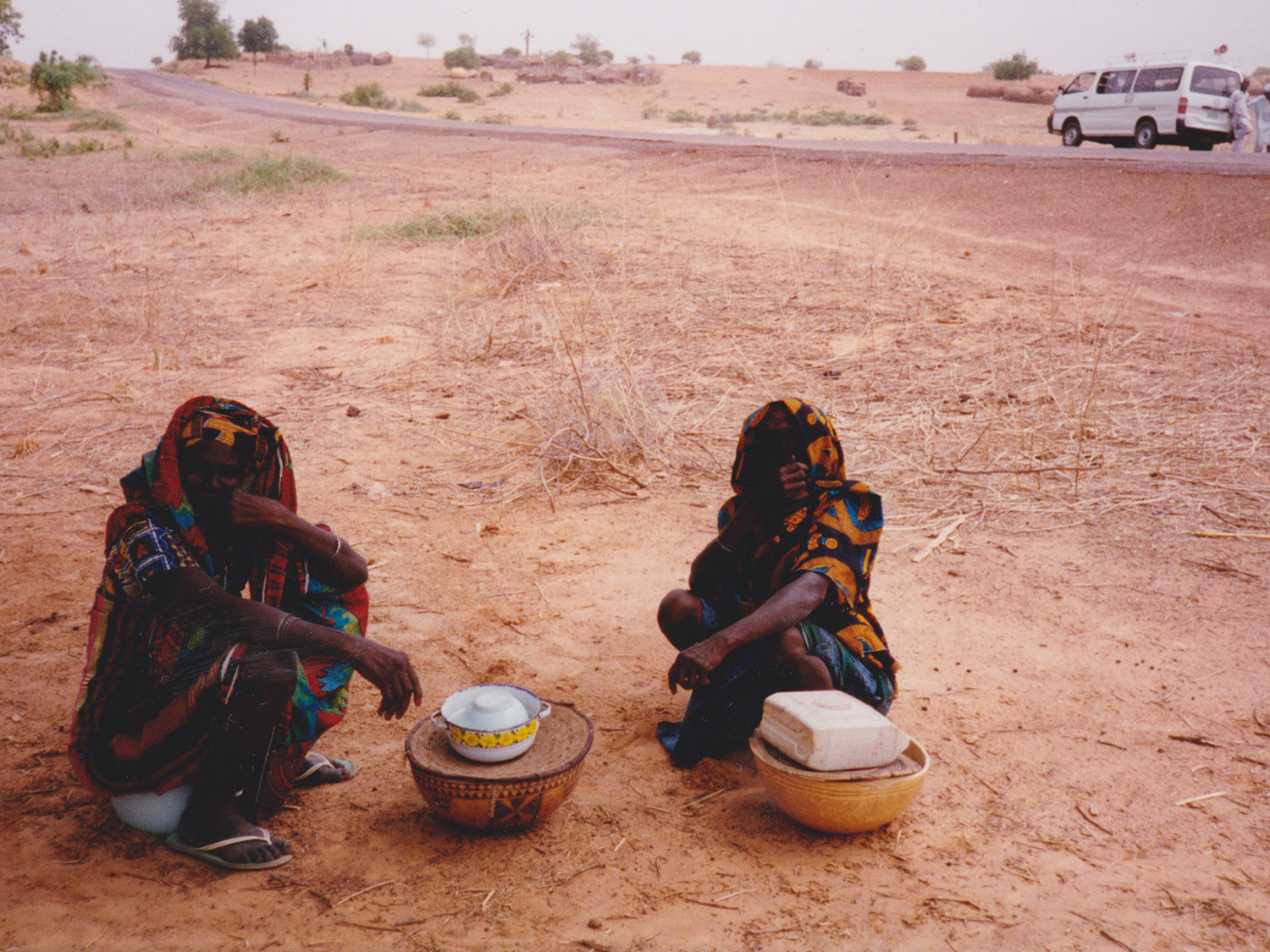 Two women sell roadside refreshments in rural Kano