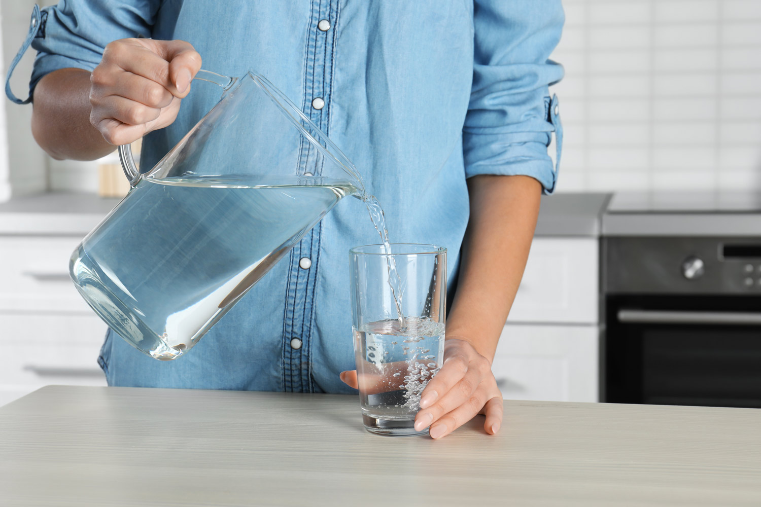 Woman pouring water into glass