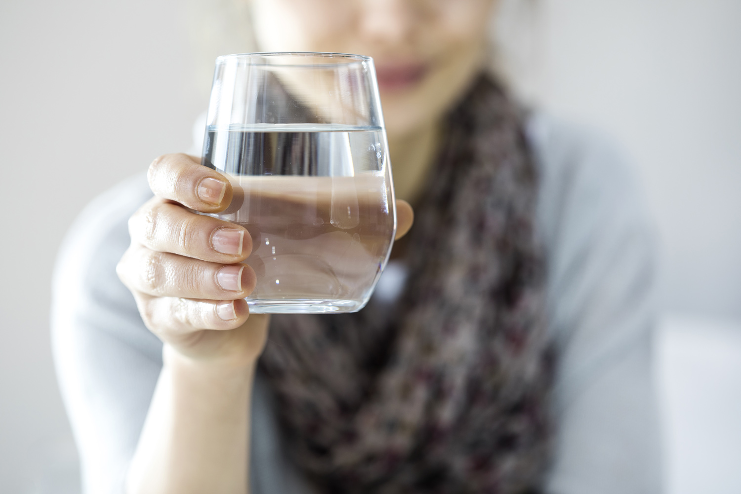 Woman holding glass of water