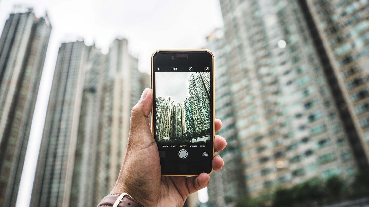 Hand holding an iPhone and taking a picture