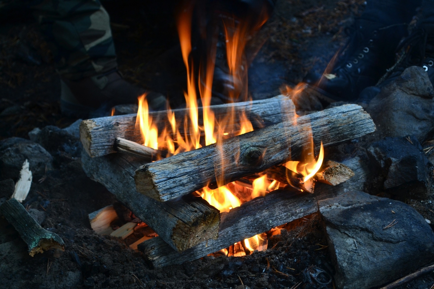 firewood stacked over a fire`