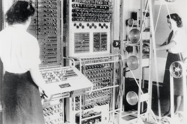 woman in front of an old computer